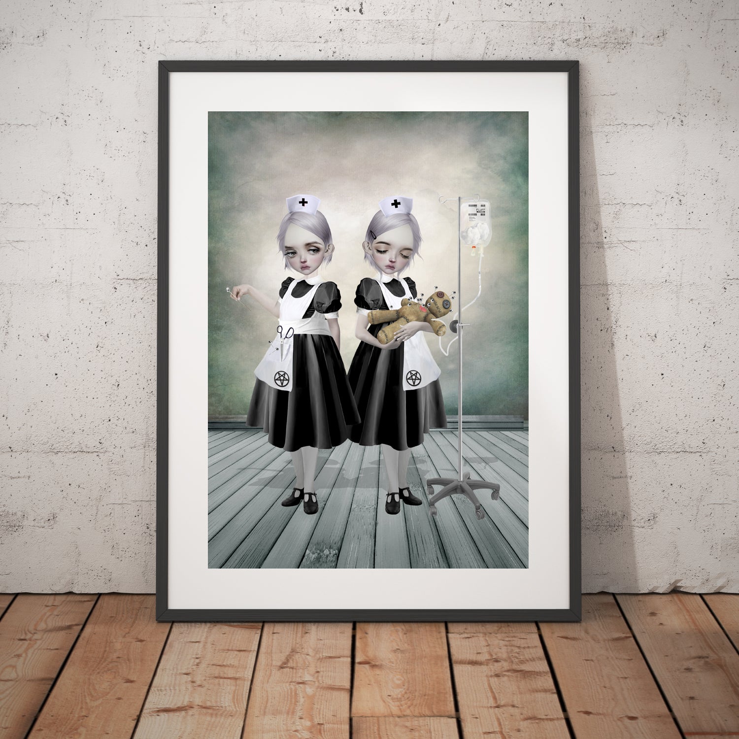 Dark Art Print features a striking image of two Gothic nurses attending to a voodoo doll. One is inserting pins while the other administers a curious fluff drip. 
