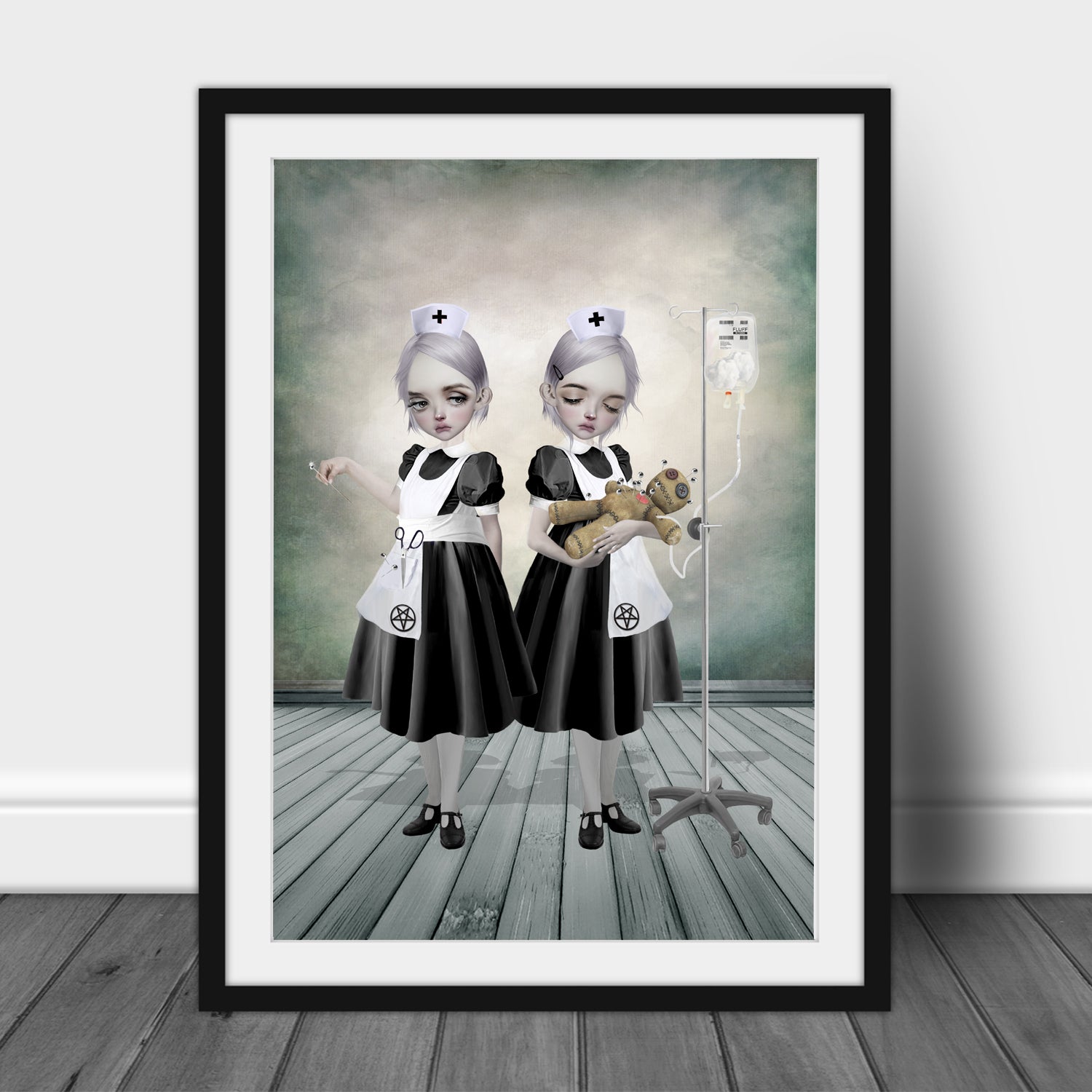 Gothic Art Print in frame features two Gothic nurses attending to a voodoo doll. One is inserting pins while the other administers a curious fluff drip.