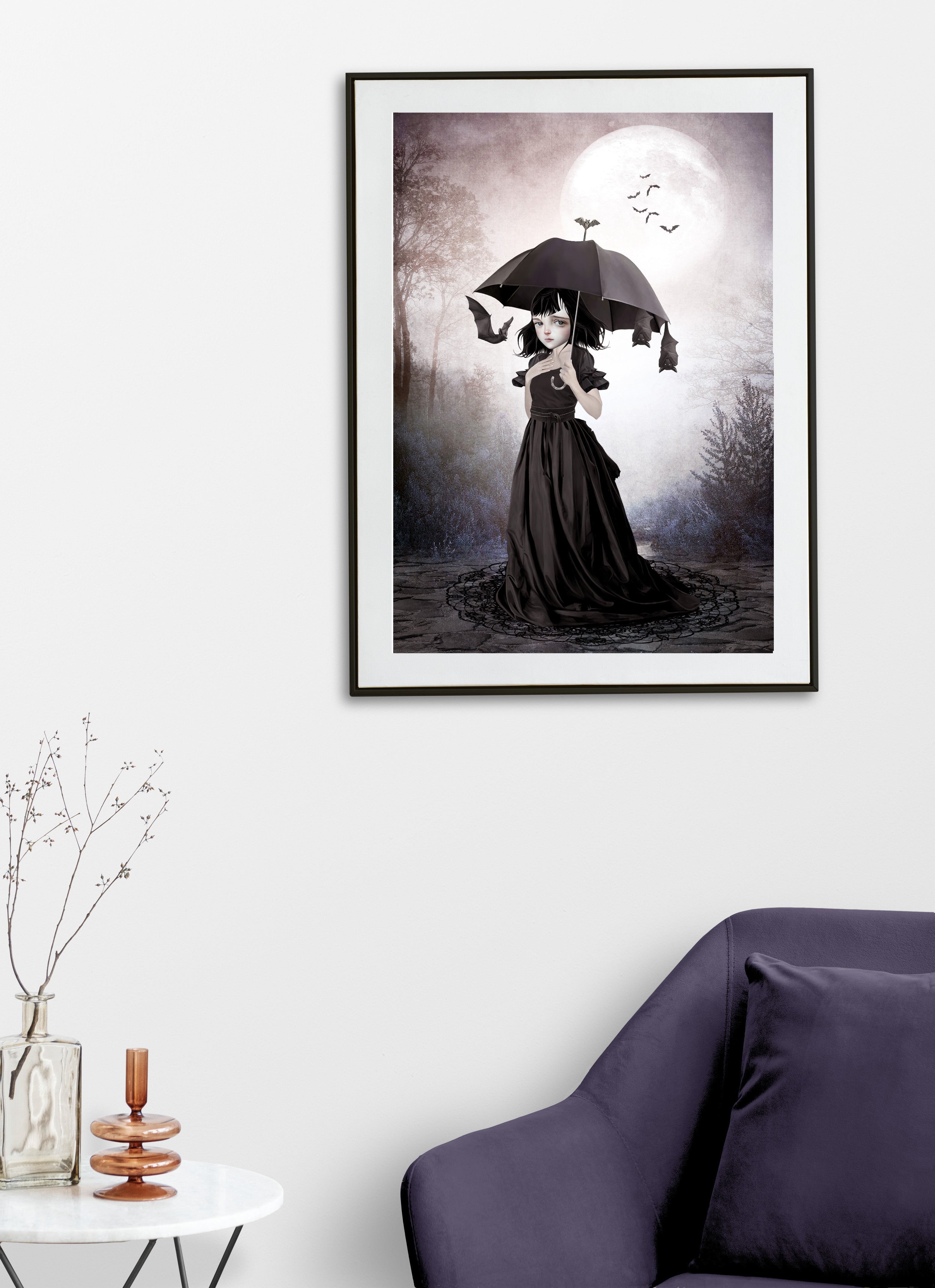 Framed artwork of dark fantasy art  featuring a gothic girl with a black umbrella and flying bats, displayed in a living room.