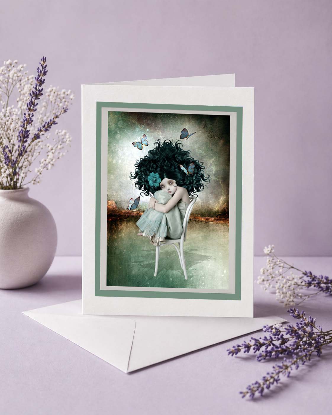 Greeting card with an artistic illustration of a girl with dark hair and butterflies, surrounded by flowers on a purple background.