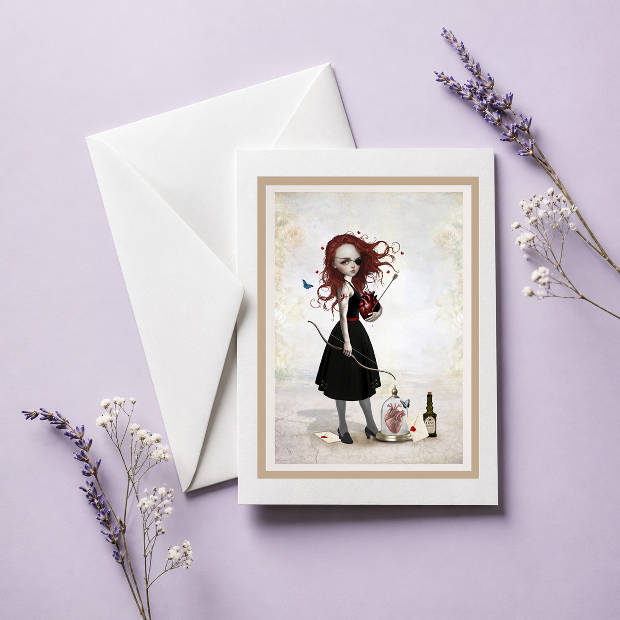 Whimsical Love archer art greeting card and envelope, featuring a Pop Surrealism illustration of a gothic redhead archer holding an anatomical heart.