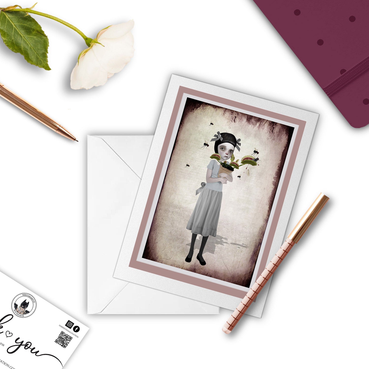 whimsical Venus Fly Trap Art greeting card with pen and other stationary items arranged around it.