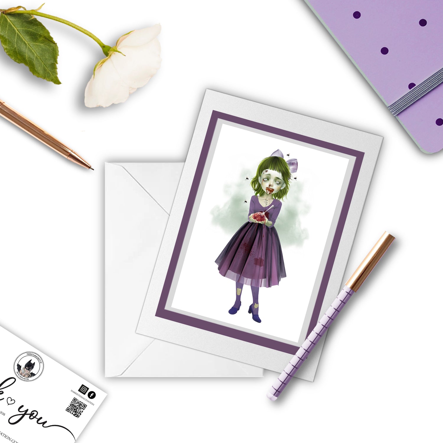 Zombie Girl greeting card beside a notebook and pen – perfect for gifting or writing a creepy, poetic note.