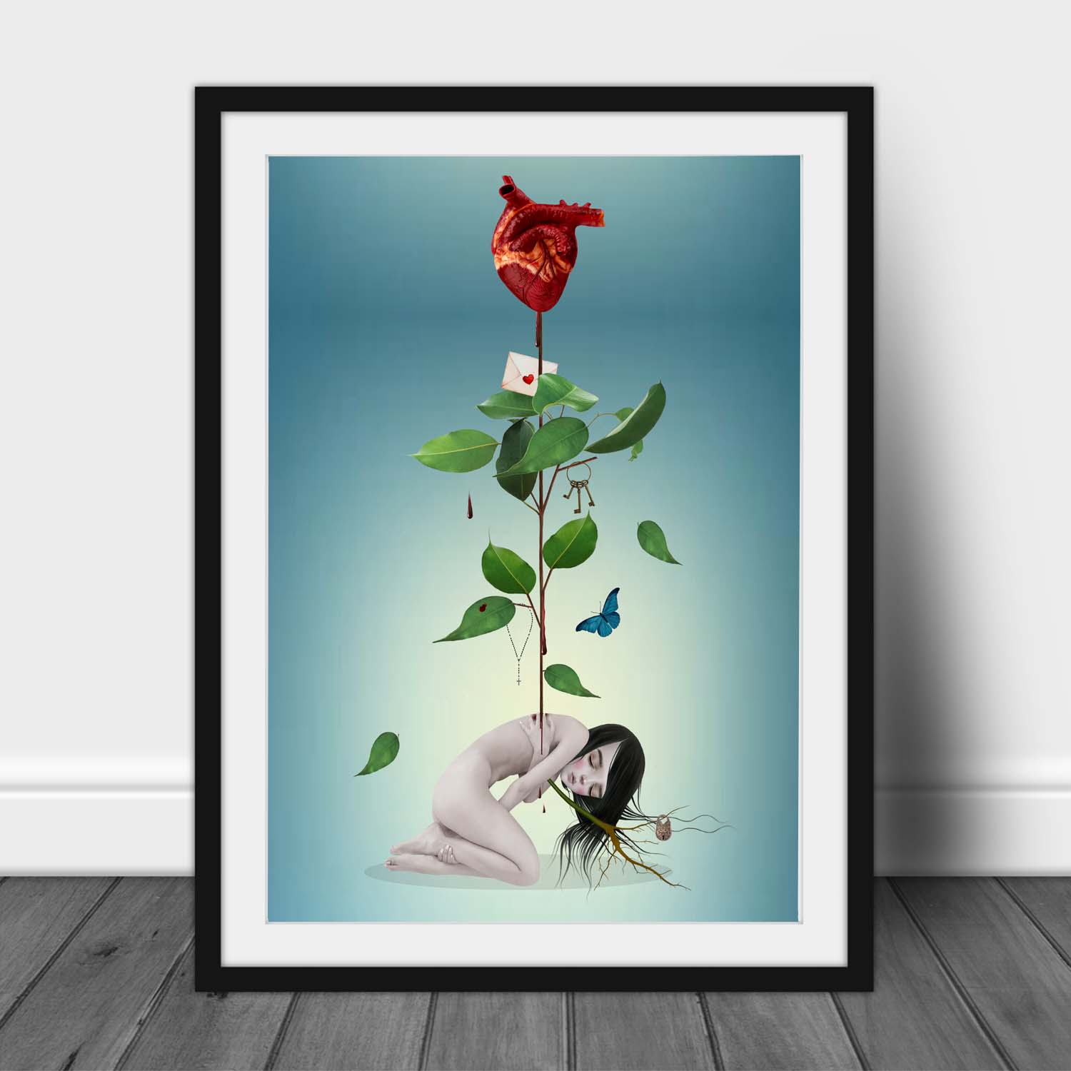 Black framed surreal gothic anatomical heart artwork featuring botanical leaves, a blue butterfly, and a resting feminine figure on a teal background.