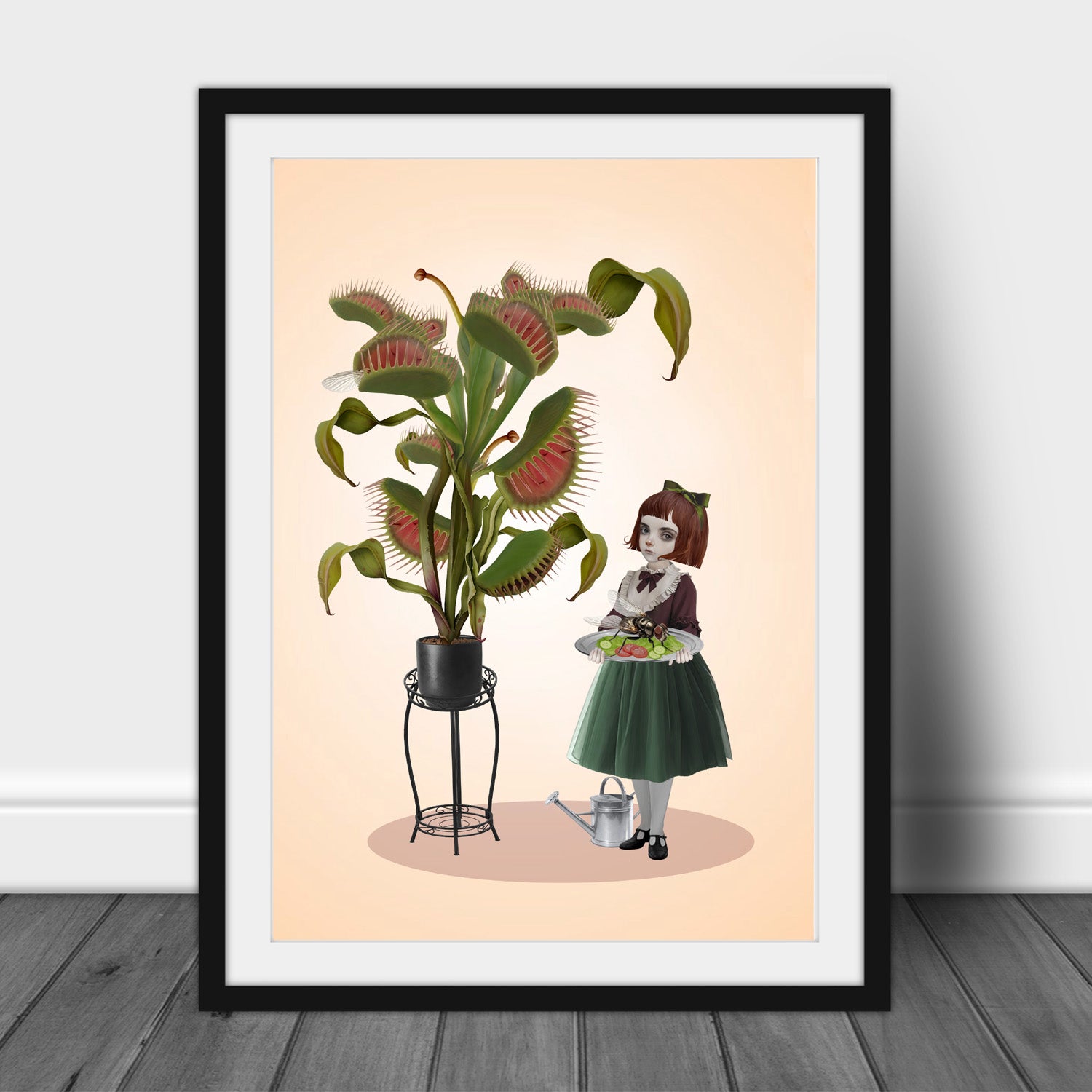 Black framed Botanical Banquet art print leaning against a white wall, showcasing the surreal illustration of a Victorian girl with a giant Venus flytrap.