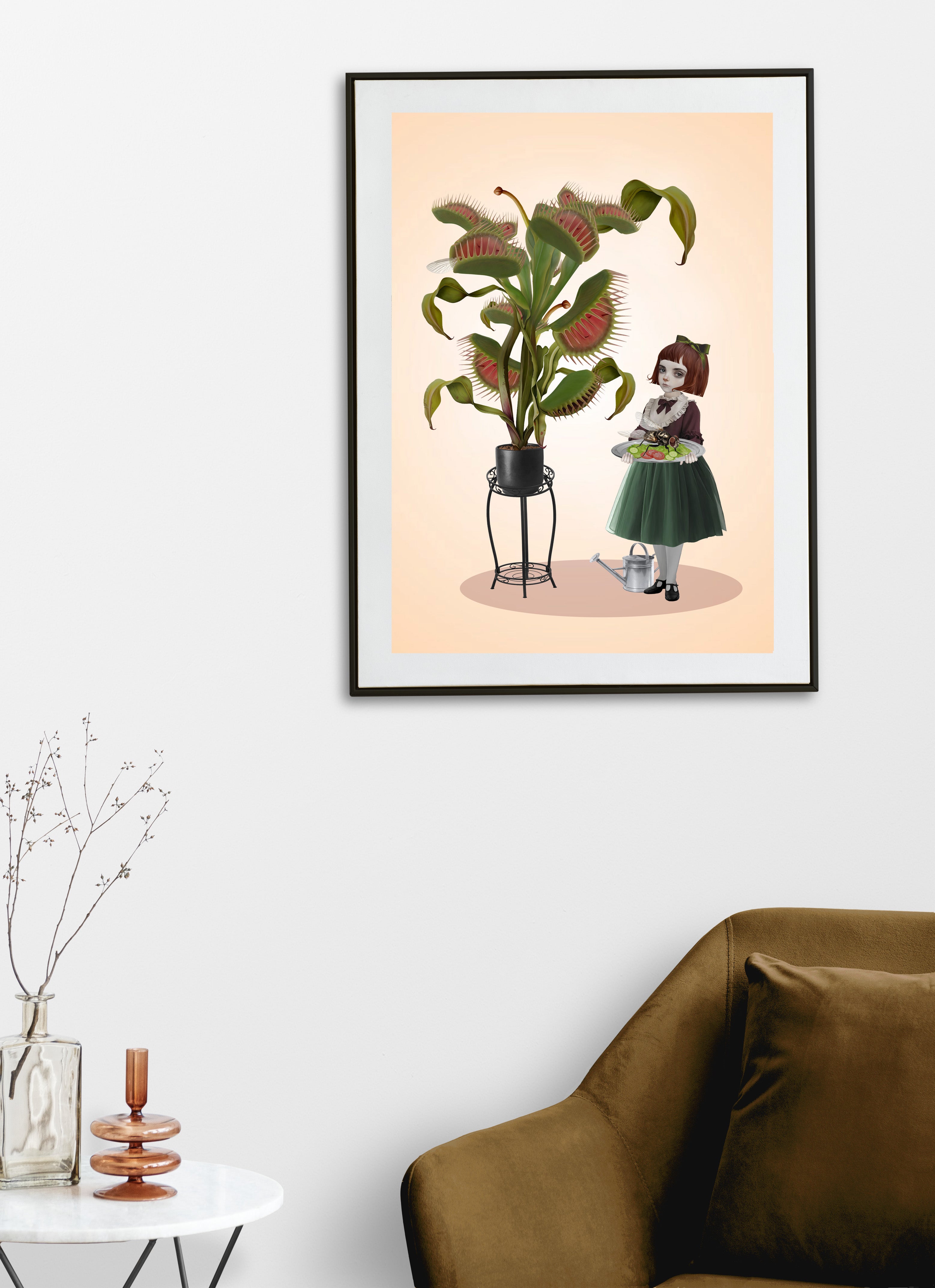 Surreal macabre art print in a black frame displayed on a white wall above a chair, featuring the Botanical Banquet illustration of a Victorian girl and Venus flytrap.