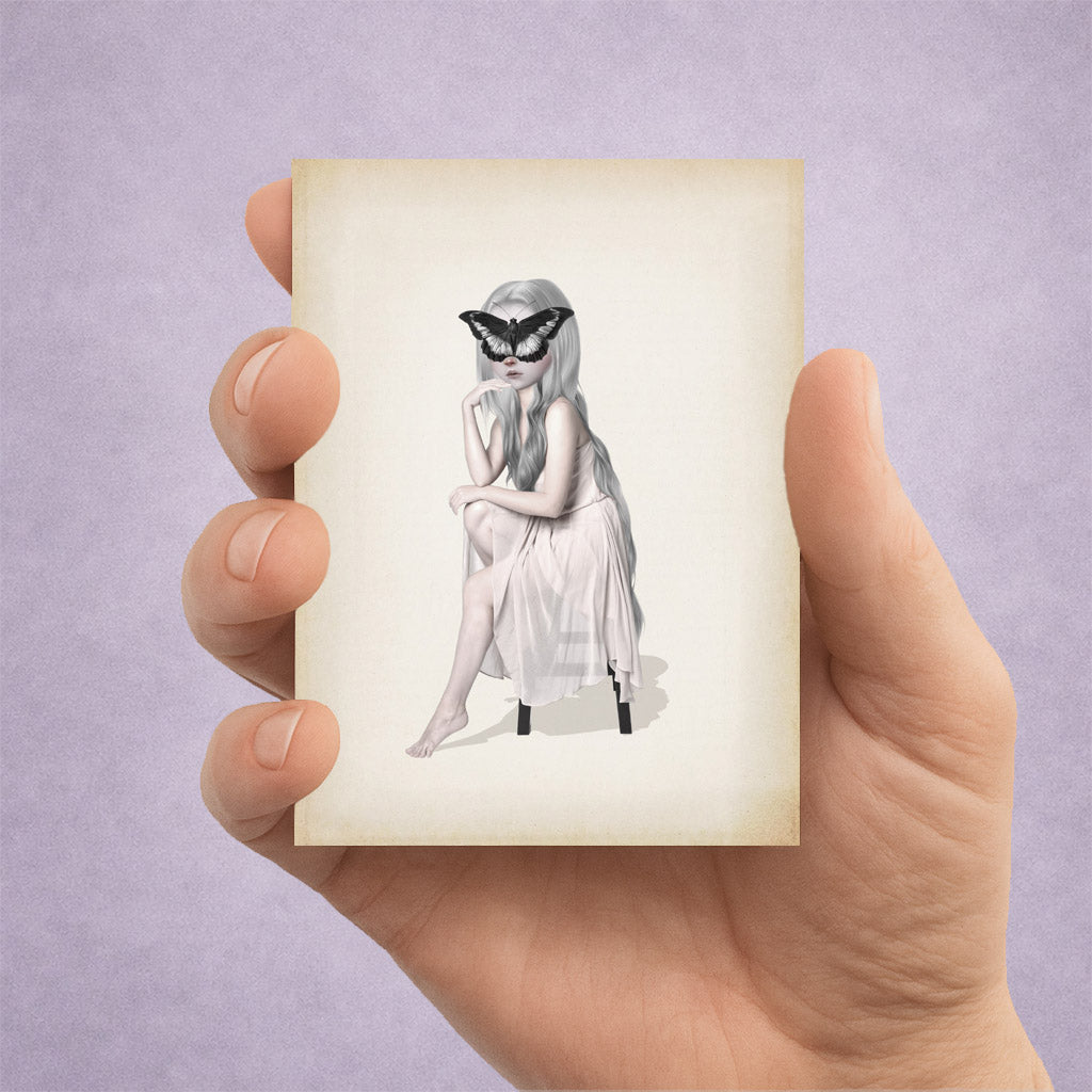 Girl with a butterfly on her face ACEO art card print held in a hand to show miniature scale.