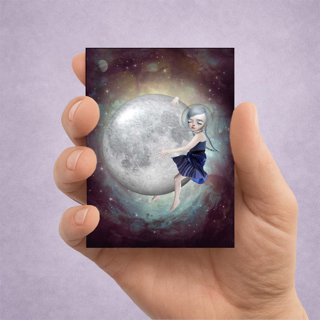 Cosmic Moon Girl ACEO art card held in hand featuring a surreal celestial girl embracing the moon