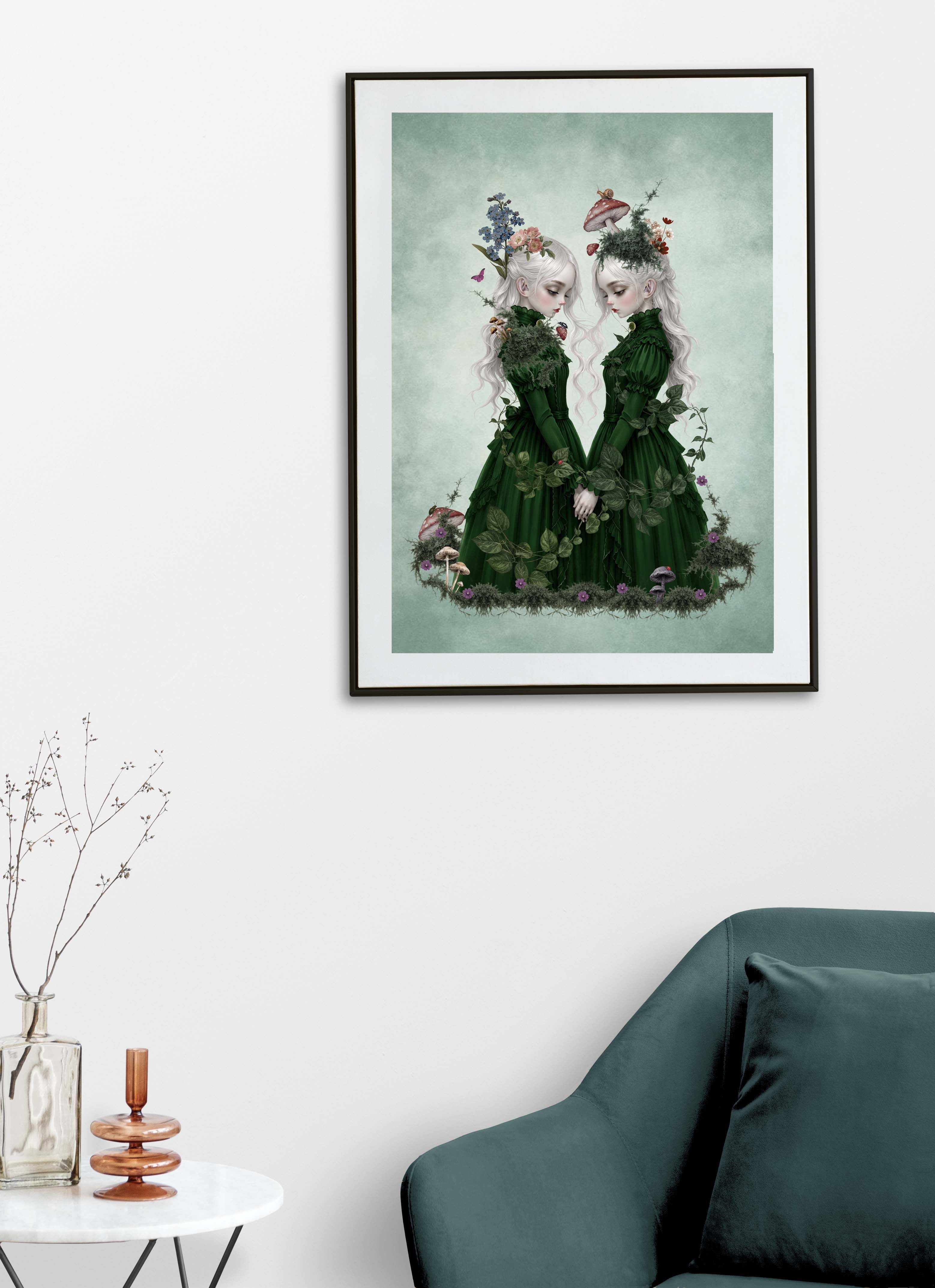 Art print displayed on a living room wall featuring two ethereal twin girls with long white hair wearing dark green Victorian dresses, holding hands amidst moss, mushrooms, and forget-me-nots in a dark cottagecore fantasy art print.