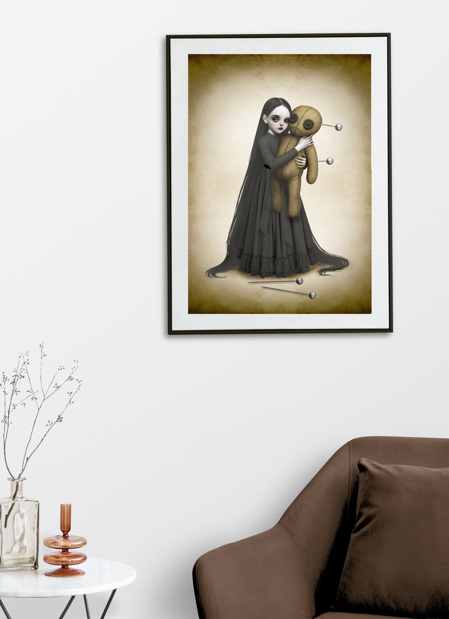 Goth girl and voodoo doll art print framed and hanging on a living room wall.