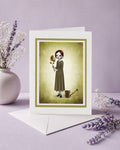 Greeting card with a illustration of a woman holding a flower with a face on a purple background