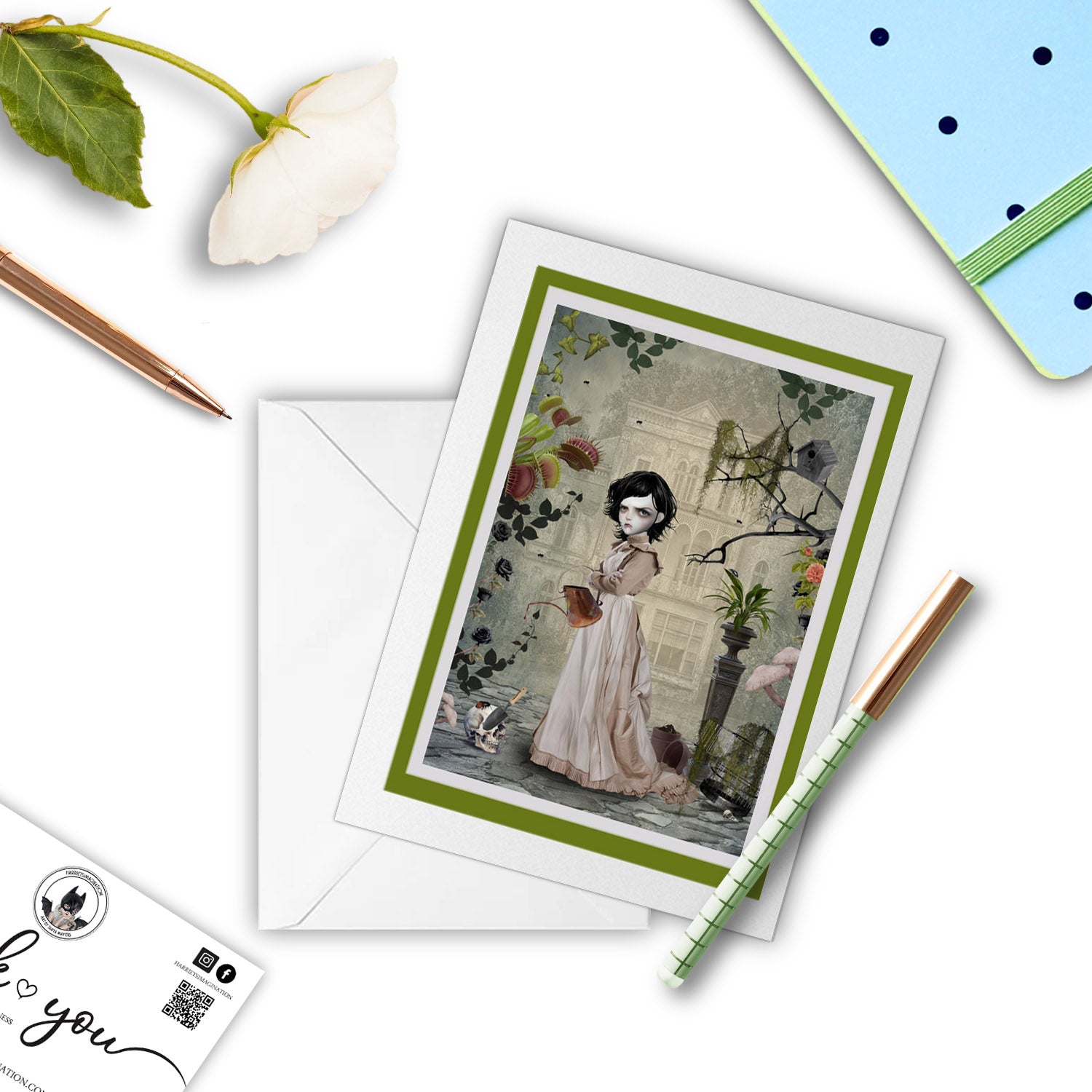 rary Mary Art Greeting Card, with a pen and other stationary items around it.