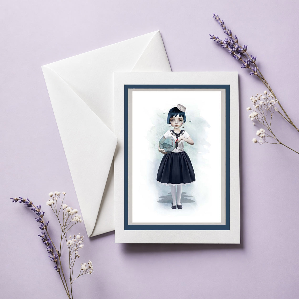 Greeting card with illustration of a sailor girl holding a fishbowl with miniature shark, accompanied by an envelope on a light purple background.