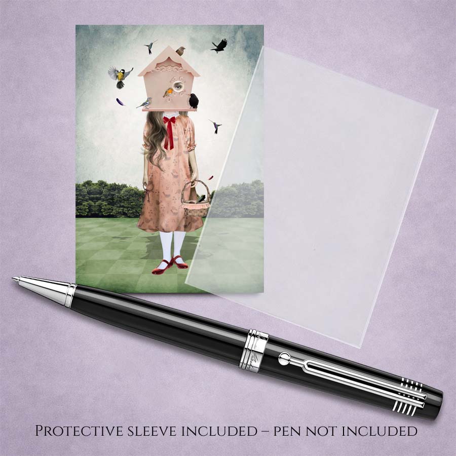 Surreal ACEO Art Trading Card Birdhouse Girl Illustration in a clear protective sleeve displayed next to a pen for scale reference.