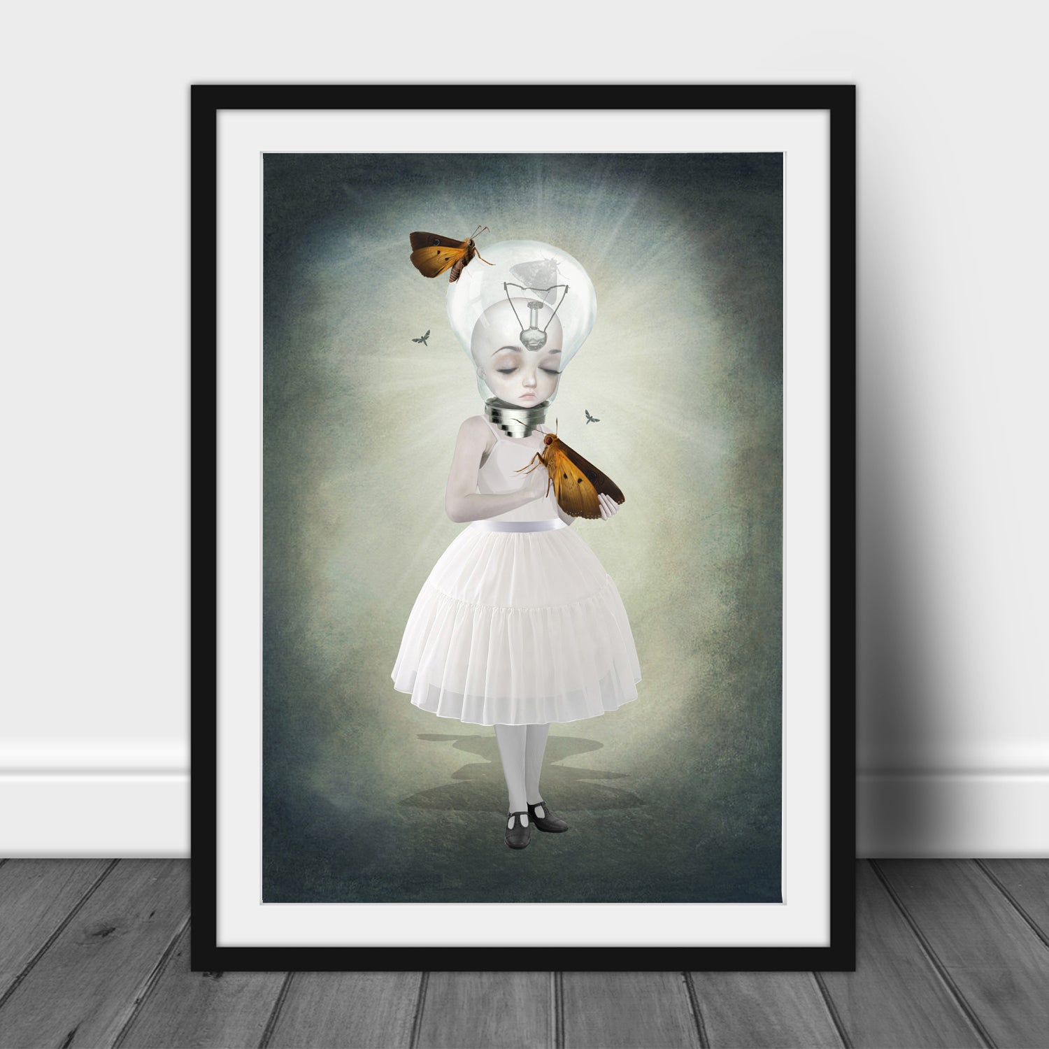 Framed artwork of a girl with a light bulb head surrounded by moths on a dark background.